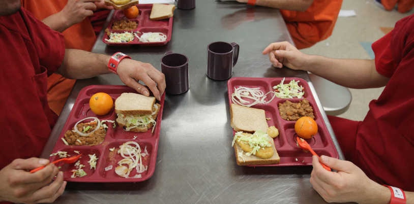 Des détenus mangent leur déjeuner, à la prison d'Adelanto, en Californie, en 2013.
